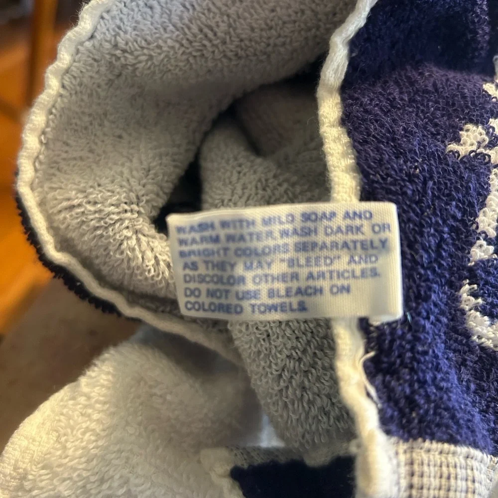 2 sports towels. 1 is reversible and has a tennis player. 1 is izod brand.